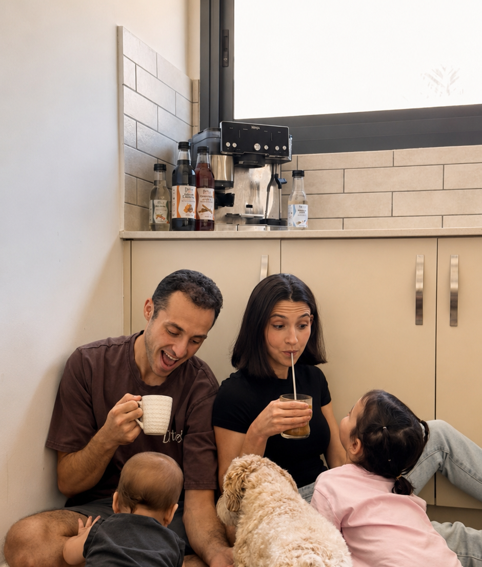 Niki, Isaac, their kids, and their dog Carl sharing coffee in the kitchen
