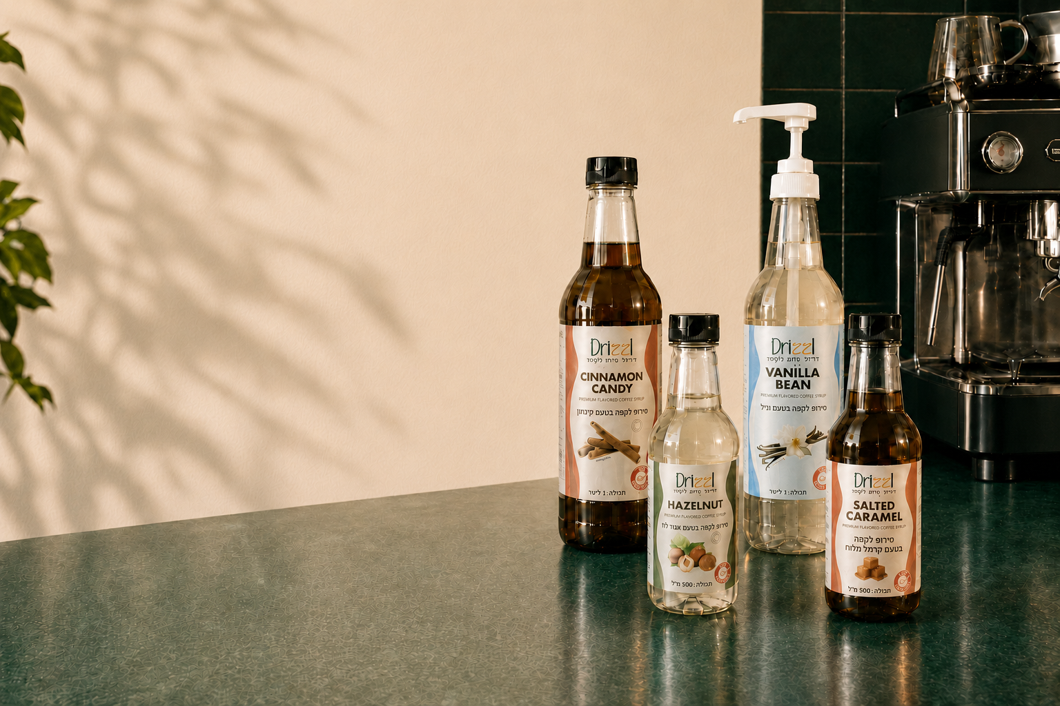 The full Drizzl coffee syrup lineup — Salted Caramel, Vanilla Bean, Hazelnut, and Cinnamon Candy squeeze and pump bottles