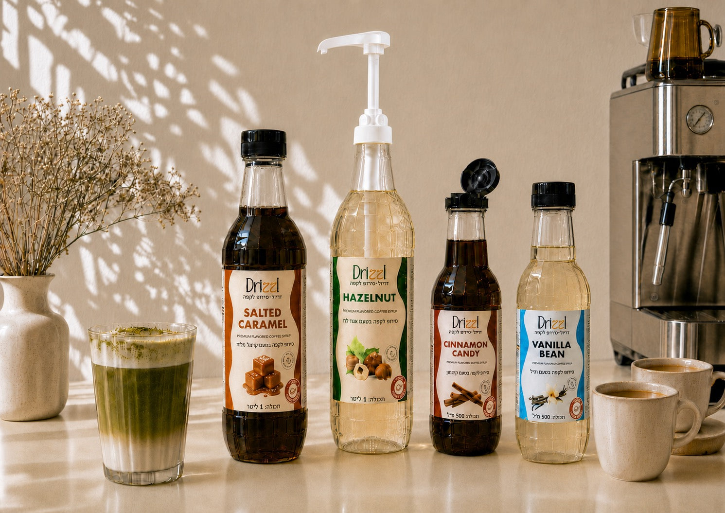 Drizzl coffee syrup lineup — Vanilla Bean, Cinnamon Candy, Hazelnut, and Salted Caramel — on a wooden shelf