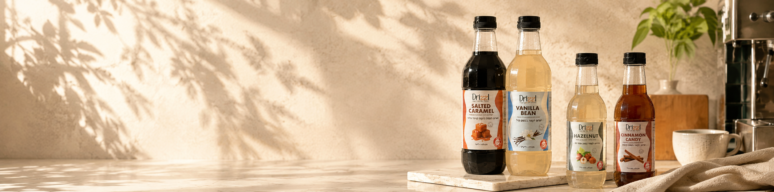 Drizzl coffee syrup lineup — Hazelnut, Cinnamon Candy, and Vanilla Bean on a sunlit kitchen counter